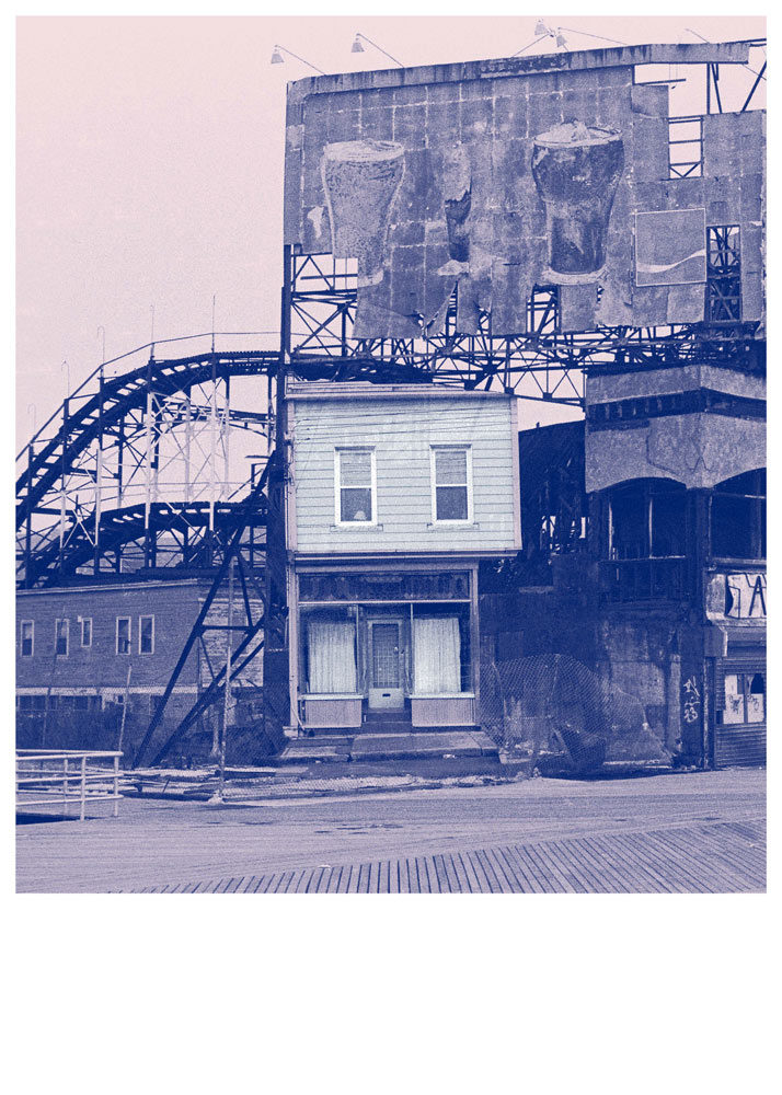 A small house is built beneath a large, weathered billboard structure next to a roller coaster on a boardwalk in Annie Hall.