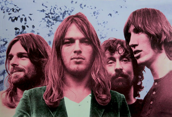 Four men with flowing, long hair gather outdoors, surrounded by the natural backdrop of trees and sky. Their faces are set in serious expressions that complement their casual clothing. This portrayal of Pink Floyd is enhanced with a vintage, artist-crafted tinting that imbues the image with an artful essence, evoking the nostalgia of a past era.
