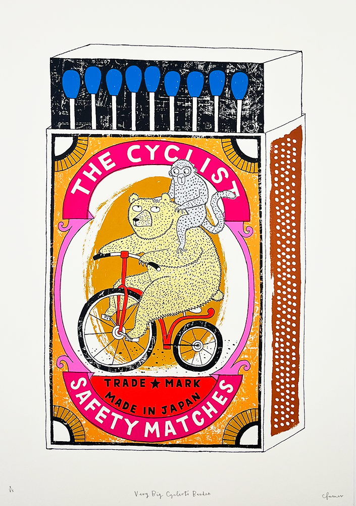 Art illustration of a vintage-style matchbox titled "The Cyclist Safety Matches." This creative depiction includes a whimsical scene where a bear is seen pedaling a bicycle, while accompanied by a monkey perched on its back, seamlessly flowing through the composition. The design bursts with vibrant colors and incorporates Japanese characters, alongside an array of matches displayed along the edge of the box.