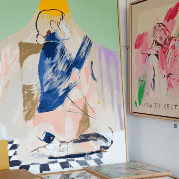 Two framed paintings: one of a person kneeling on a checkered floor, the other of a seated person reading with the text "HOW TO REST." Both use expressive, loose brushstrokes.