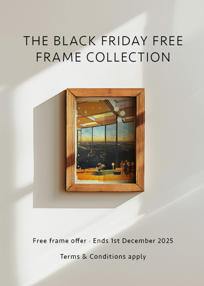 A wooden picture frame with art hangs on a white wall. Text above reads "The Black Friday Free Frame Collection." Offer details and terms appear below.