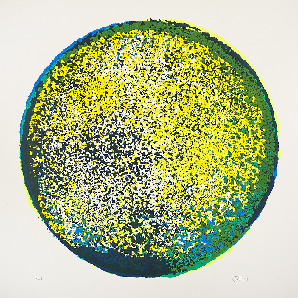 A circular abstract artwork featuring densely clustered yellow, green, blue, and white dots against a plain white background.