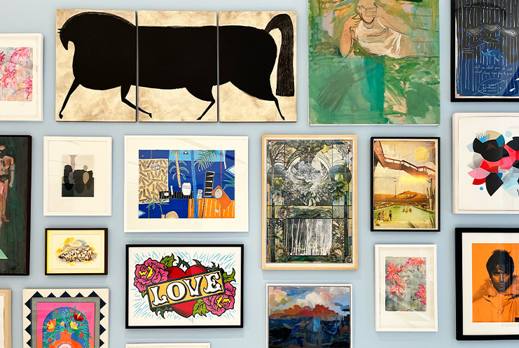 A collage of various framed artworks, including limited edition prints, abstract, landscape, and figurative paintings, arranged in a grid on a light-colored wall.