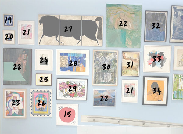 A gallery wall displays 20 framed artworks of varying sizes and styles from The Bishopsgate Collection art, each marked with a unique black number between 15 and 34.