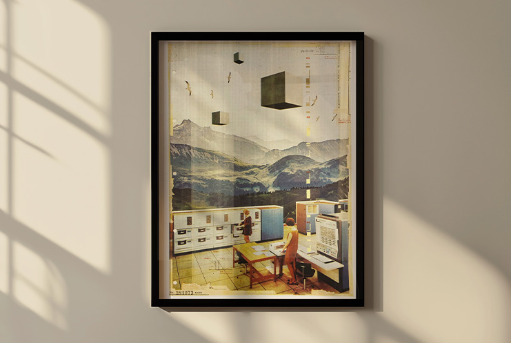 Framed limited edition art on a wall shows a surreal collage of a person at a desk with office equipment in front of a mountainous landscape and floating black cubes.