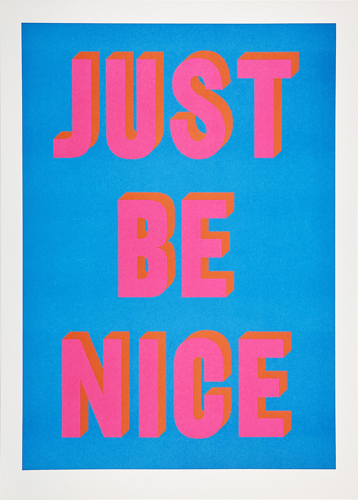 Text reading “JUST BE NICE” in large, bold, pink and orange 3D-style letters on a bright blue background.