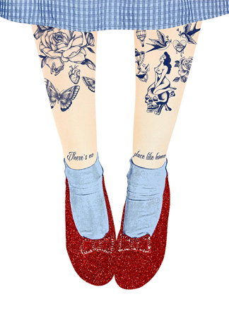 A person wearing blue gingham clothing and red glitter shoes; legs have tattoos of flowers, butterflies, a pin-up, and text reading, "There’s no place like home.