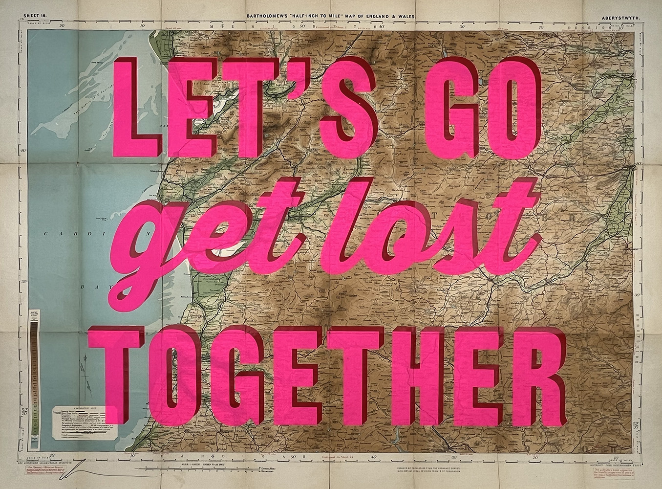 A vintage map of the UK with bold pink text overlaid that says “LET’S GO get lost TOGETHER.”.