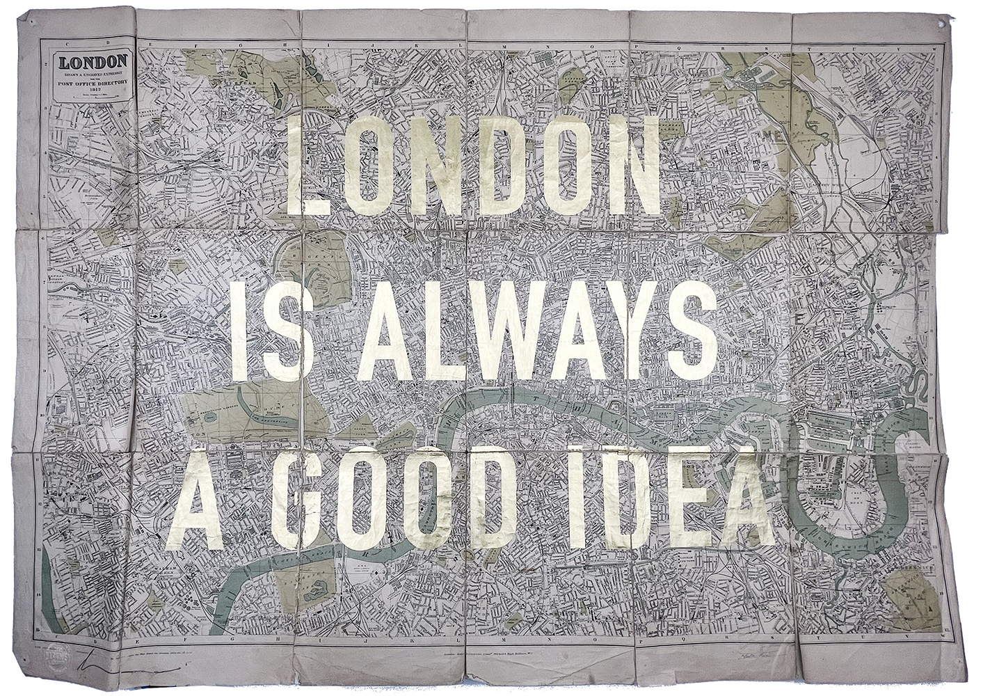 A vintage 1912 map of London with “LONDON IS ALWAYS A GOOD IDEA” in large white letters and gold leaf accents.