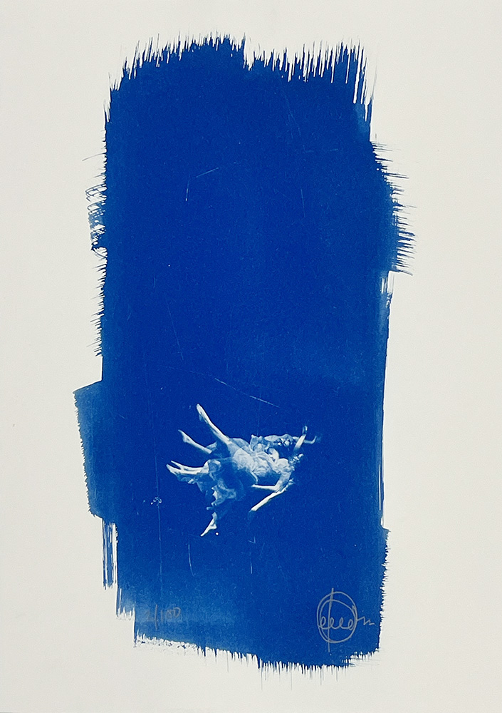 A print shows two dancers in mid-movement inside a rectangle of deep blue brushstrokes on a white background.