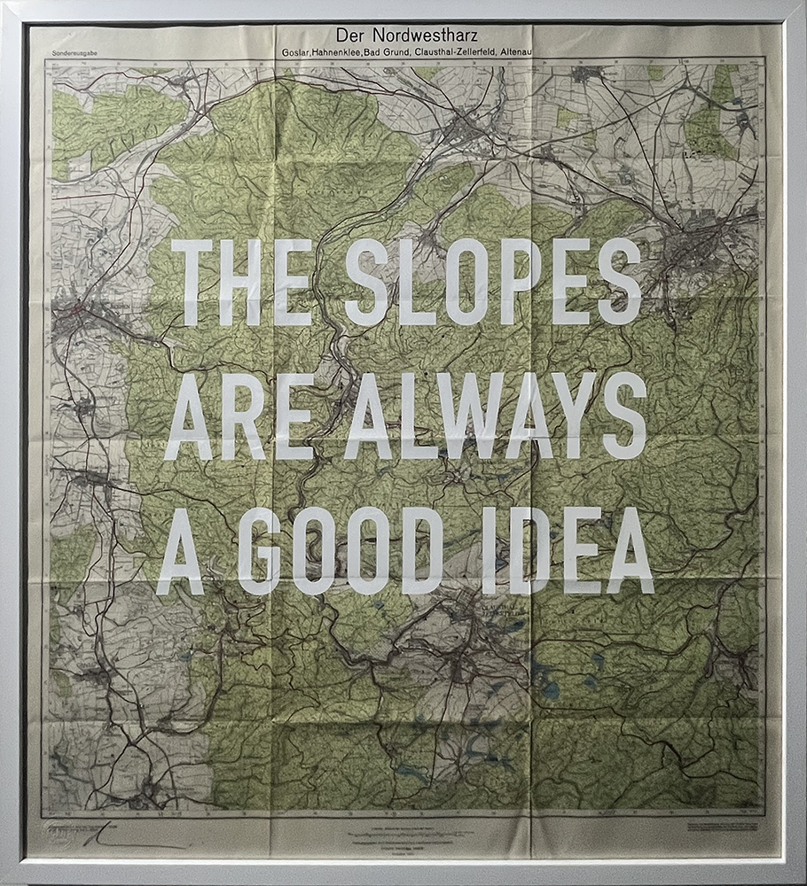 A framed map labelled “Der Nordwestharz” features large white text across it reading “THE SLOPES ARE ALWAYS A GOOD IDEA.”.