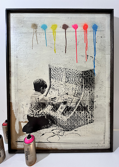 Framed artwork shows a child painting a box, six coloured paint drips above, and two spray paint cans in front.